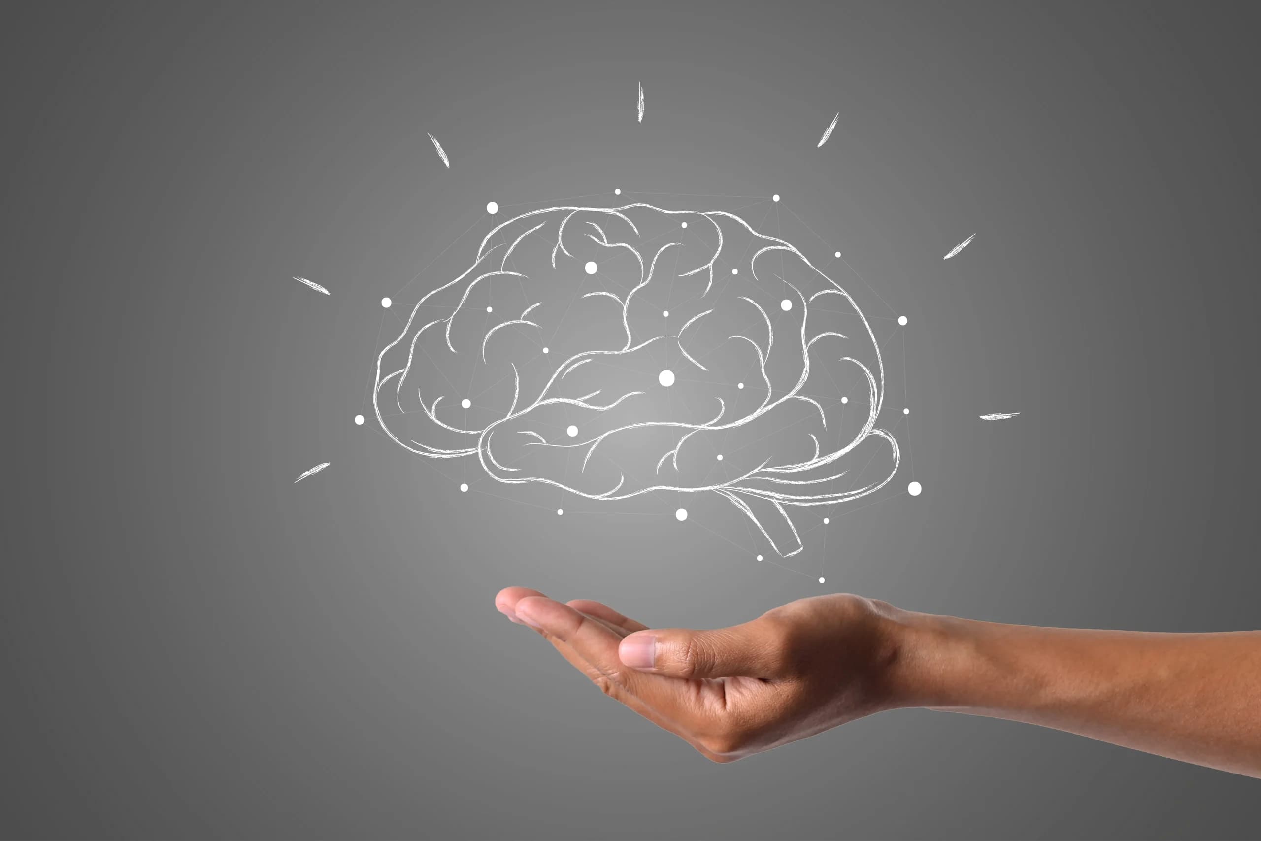 Representación digital de un cerebro flotando sobre una mano extendida, simbolizando la neuropsicología y el estudio de las funciones mentales
